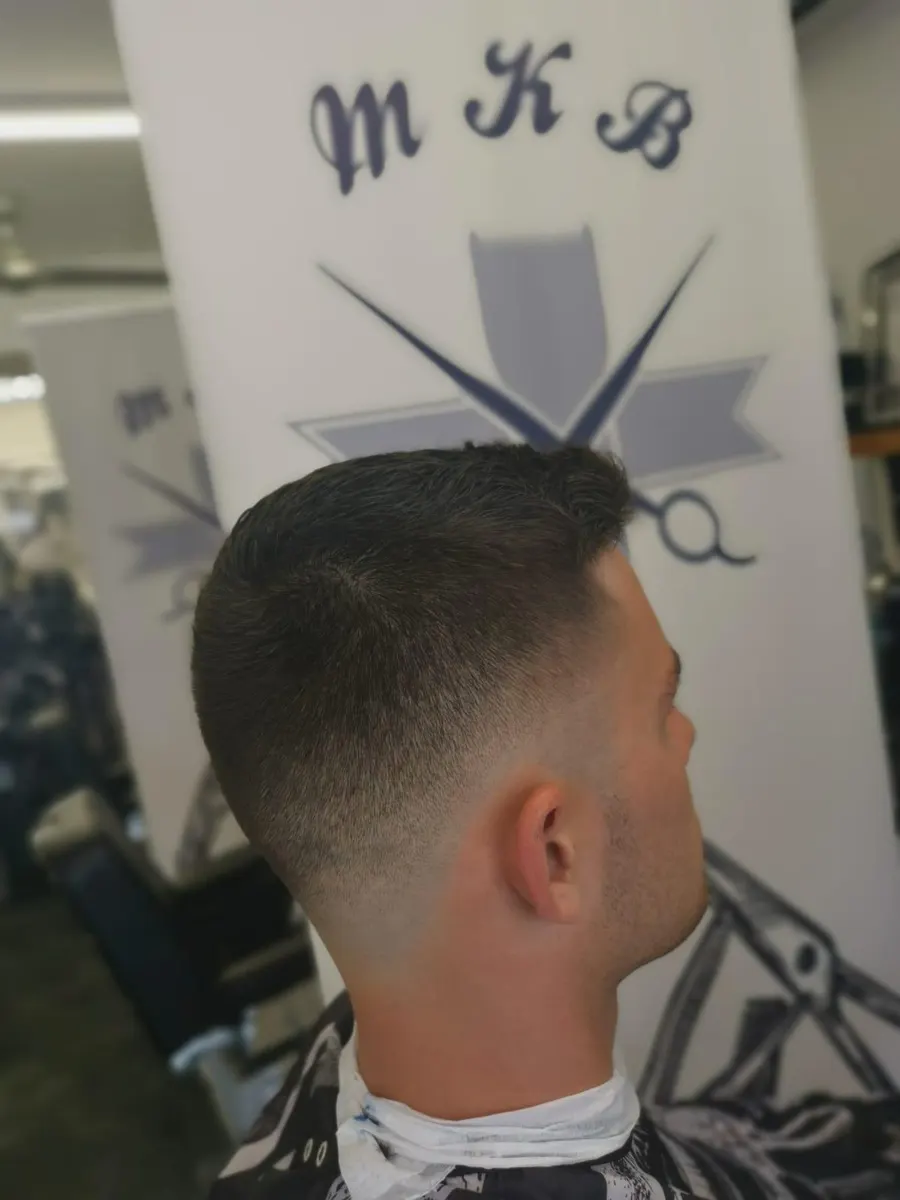 A short fade haircut seen from the side