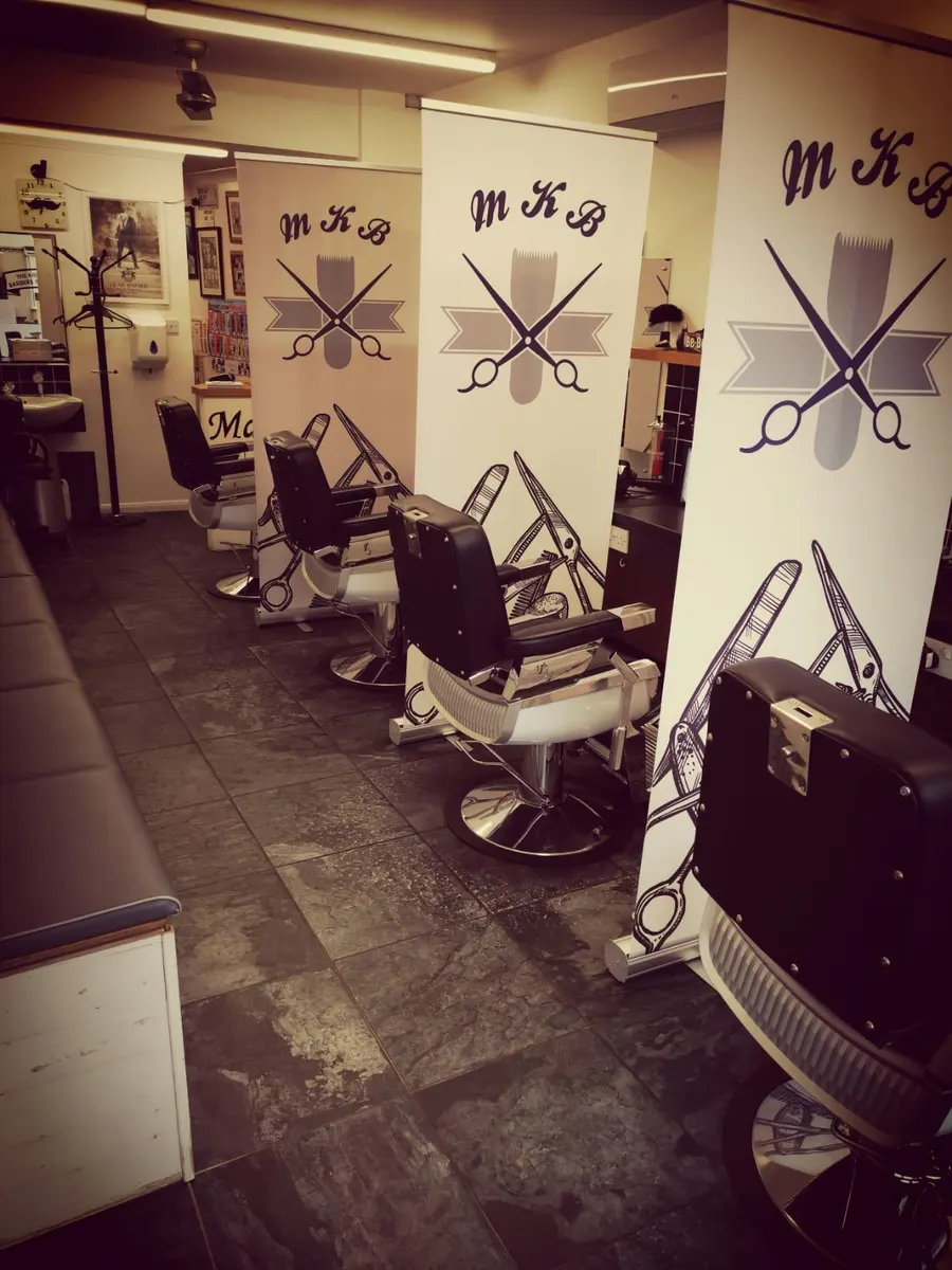 The shop interior with MKB banners and barber chairs